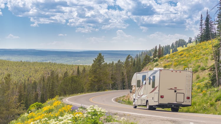 camper-driving-down-road-in-the-beautiful-countrys